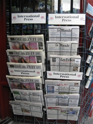 An image of international newspapers display at a newsagent